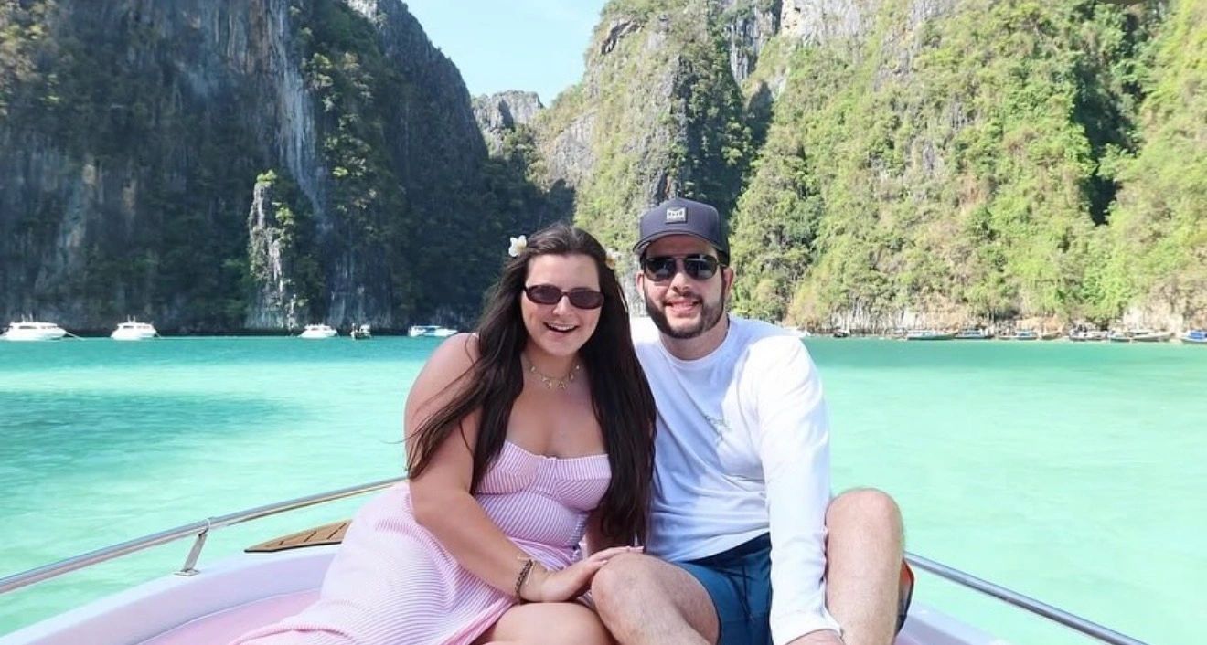 Couple on boat in tropical turquoise water.